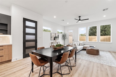 From the moment you step
inside, natural light pours
through wide picture windows,
revealing an open-concept living
space that feels both grand and
grounded.