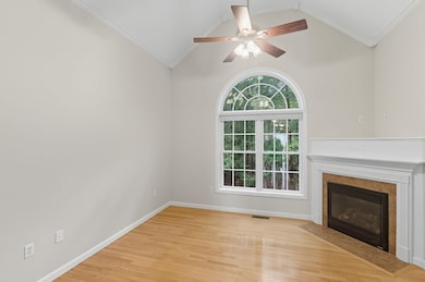 Straight ahead you'll walk into this stunning living room with cathedral ceilings with a fan
