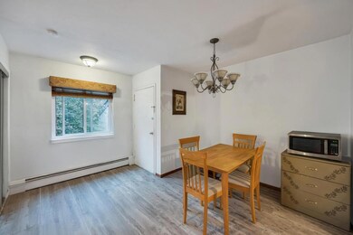 Dining room featuring light wood-type flooring, ba