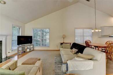 Living area with high vaulted ceiling and a chandelier