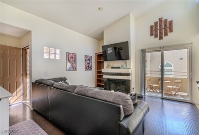 Living area featuring dark wood-style floors, a fi
