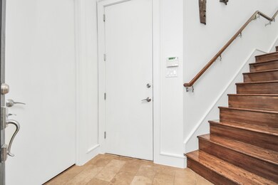 Entry with beautiful hardwood stairs