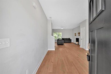Hallway with light wood finished floors and baseboards