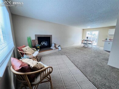 Living room featuring a tiled fireplace and carpet