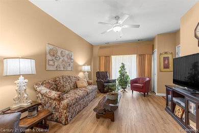 Living room featuring light wood-style floors and a ceiling fan