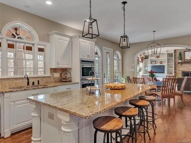 Kitchen Island with room for four chairs. Beautiful hardwood floors