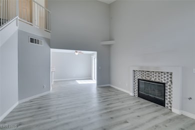 Unfurnished living room featuring a towering ceili