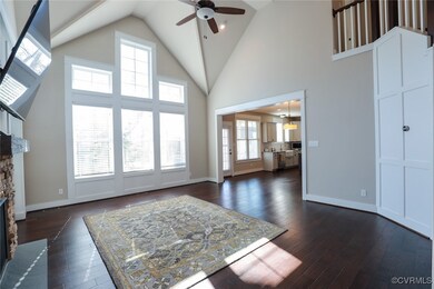 Living room with ceiling fan, high vaulted ceiling
