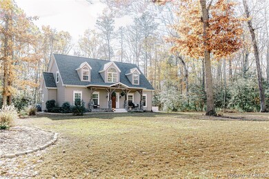 Cape cod home featuring a front lawn