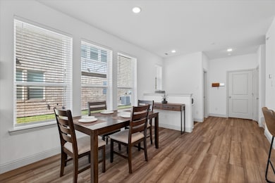 Dining space featuring plenty of natural light, light wood-type flooring, and recessed lighting