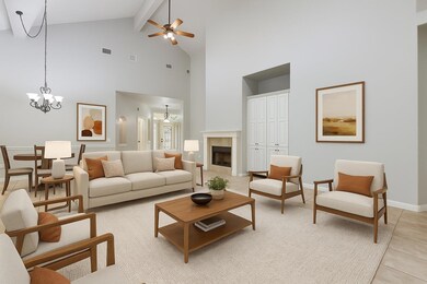 Living area featuring high vaulted ceiling, a cei