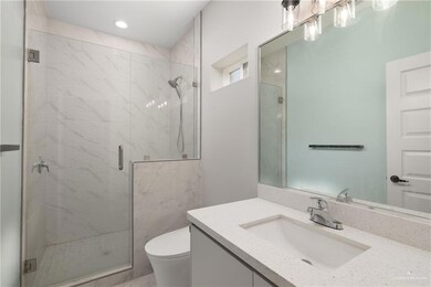 Bathroom featuring vanity and a shower stall