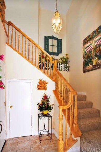 Enter from the front door to a Elegant open stairc
