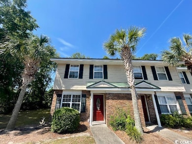 View of property featuring brick siding