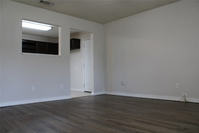 Unfurnished room featuring dark wood-style floors and a textured ceiling