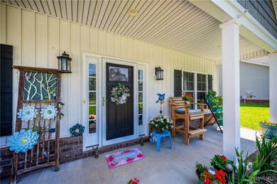 Doorway to property with a porch and board and bat