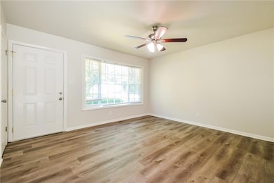 Entrance foyer featuring a ceiling fan, wood finis
