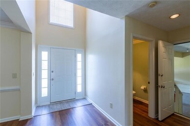 Foyer entrance with wood finished floors, healthy amount of natural light, and baseboards