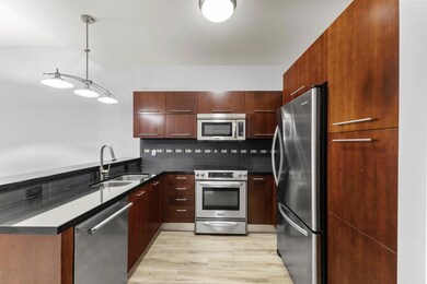 Kitchen featuring dark countertops, decorative ba