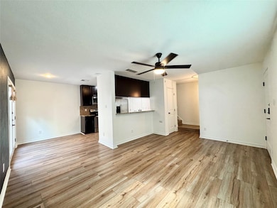 Unfurnished living room with ceiling fan and ligh