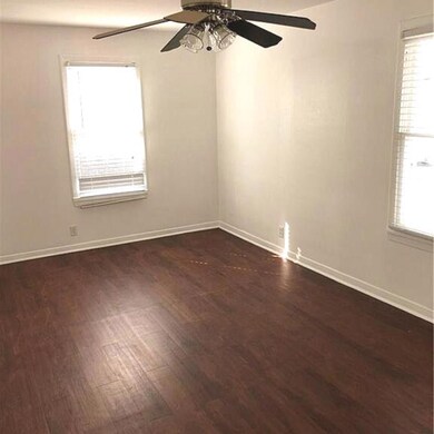 Unfurnished room with baseboards, dark wood-style