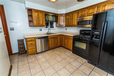 Beautiful warm wood cabinetry makes the kitchen ex