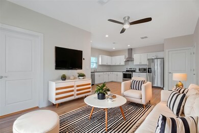 Living area with light wood-style floors and a ce
