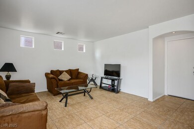 Living room featuring light tile patterned floors,