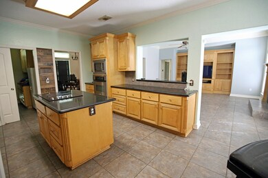 The kitchen opens into the Living Room, the Utilit