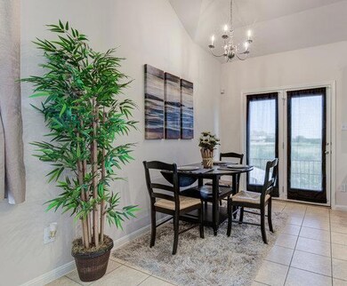 Dining area with a chandelier, light tile pattern
