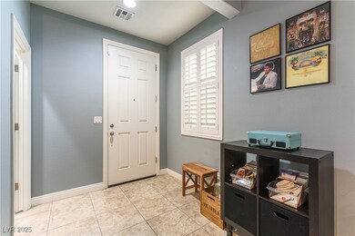 Entrance foyer featuring baseboards and light tile