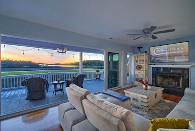 Living room featuring wood finished floors, a fireplace, and a ceiling fan