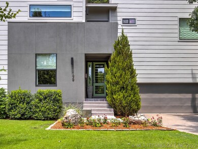 A balcony extends over the front porch.