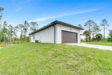 Garage featuring driveway and central AC