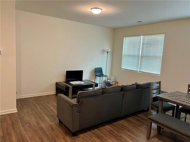 Living area with dark wood finished floors and bas