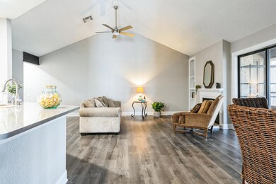 Sitting room with a fireplace, wood finished floo