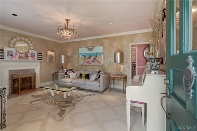 Living room featuring crown molding and a notable