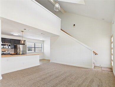 Unfurnished living room with light colored carpet,