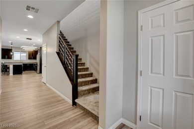 Stairs featuring wood finished floors, baseboards,
