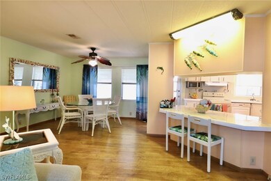 Dining area with ceiling fan, light wood-type floo