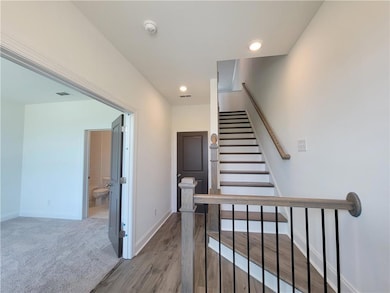 Stairway featuring carpet flooring, baseboards, vi