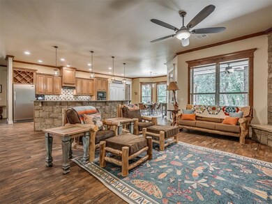Living room featuring ceiling fan, hardwood / wood