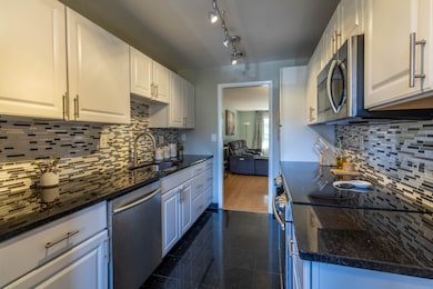 Updated Kitchen complete granite countertops & stainless steel appliances.
