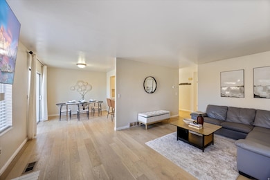 Living room with light wood finished floors and baseboards