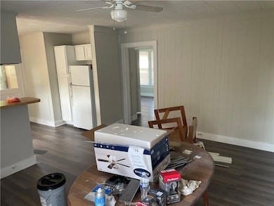 Dining room with baseboards, dark wood-style floor