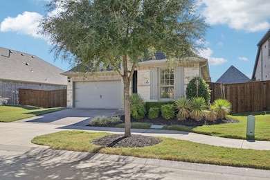 View of front facade with driveway and a garage