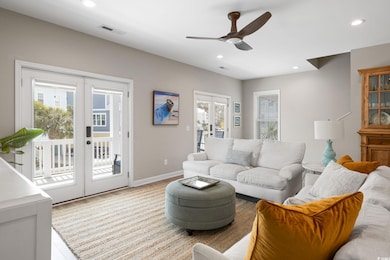 Living room featuring french doors, light wood-sty