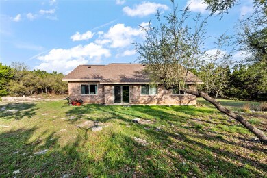 Rear view of house with a yard