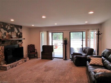 This is the large living room with 2 sliding glass doors.  The seller has his large TV in front of the beautiful Stone FP that is wood burning.