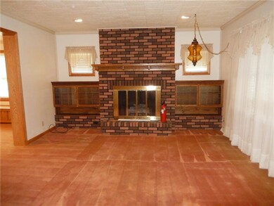 The brick fireplace is the focal point of the larg